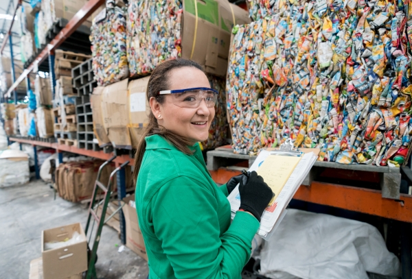Worker documenting recycled packaging